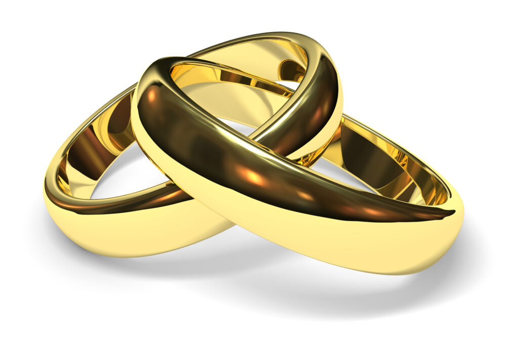 linked gold wedding rings on white background